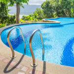 Picture of a rounded pool with a metal pool ladder